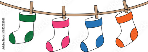 Four colorful Christmas stockings hanging on a clothesline with wooden clothespins holiday