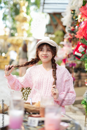  During Christmas time, a happy young woman enjoys a large Christmas gift.