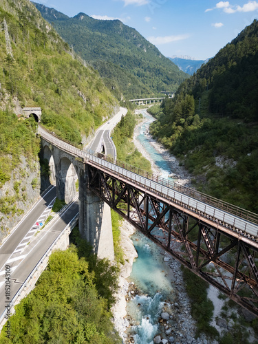 Canvas Print Alpine mountain valley with bridge and river at the Alpe Adria bicycle trail
