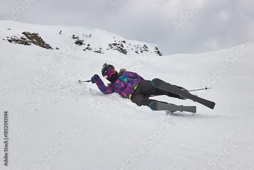 Skiing in the winter woman fallen over
