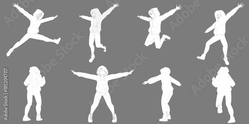 Silhouettes of people jumping and posing with arms outstretched in mid air