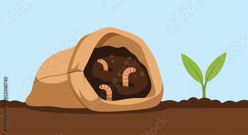 Brown bag of soil with pink earthworms inside and a small green plant seedling sprouting from the ground in a garden setting.