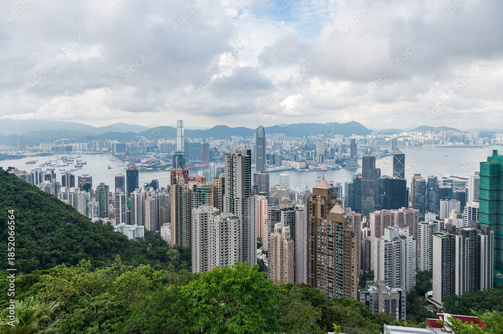 Fototapeta premium View of Hong Kong and Kowloon from Victoria peak. Panorama of Hong Kong, skyscrapers and nature. 21 May 2025, Hong Kong, China