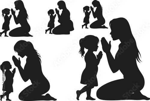 Mother and child praying together in silhouette