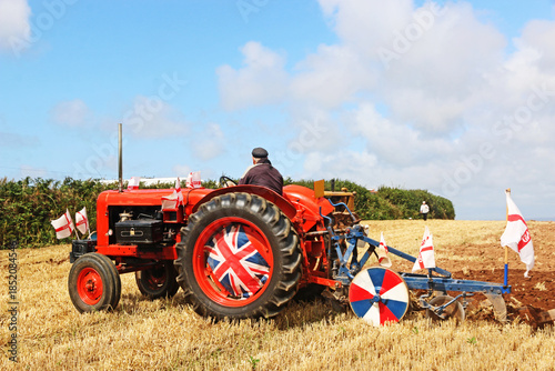 Vintage tractor ploughing a field	