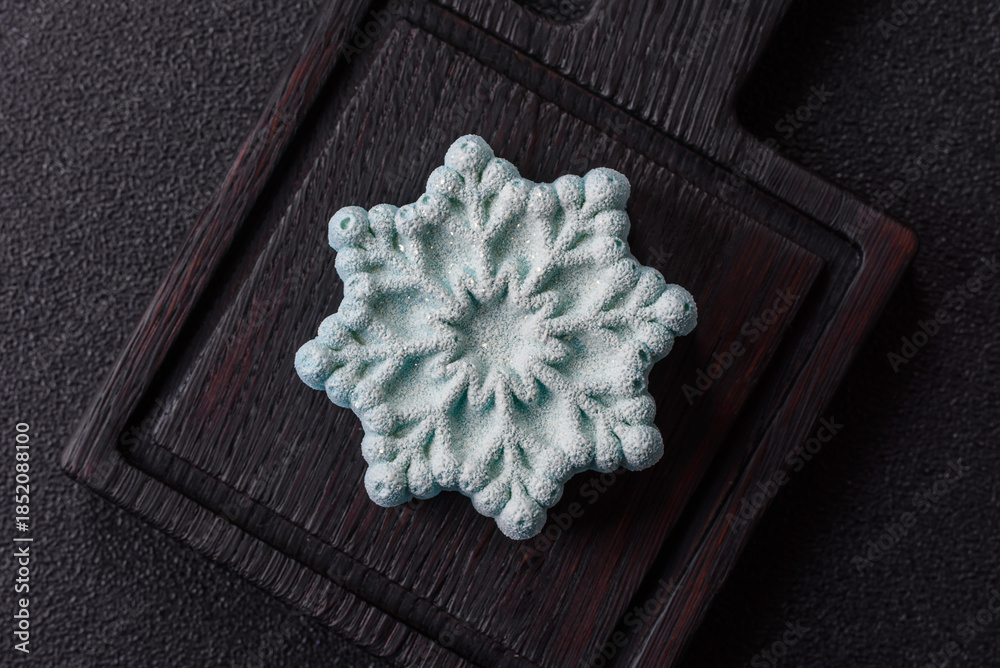 Fototapeta premium Christmas mochi, mooncake, or cheesecake shaped like a snowflake. Christmas mochi or cheesecake