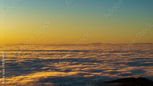 Sonnenaufgang über den Wolken in den Bergen, ein schöner Anblick für Wanderer und Naturliebhaber
