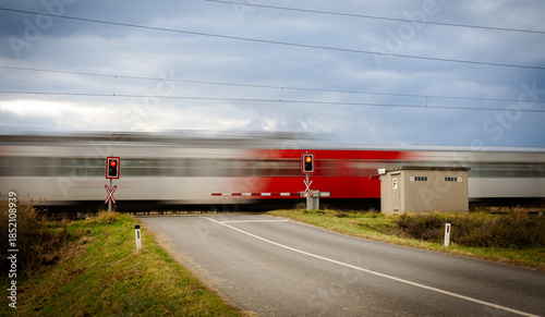 Bilde på lerret Train travels through a rural area with signals