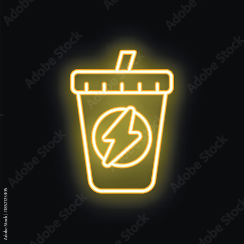 Yellow glowing neon sign depicting a plastic cup with a straw for energy drinks, shining on a dark brick wall