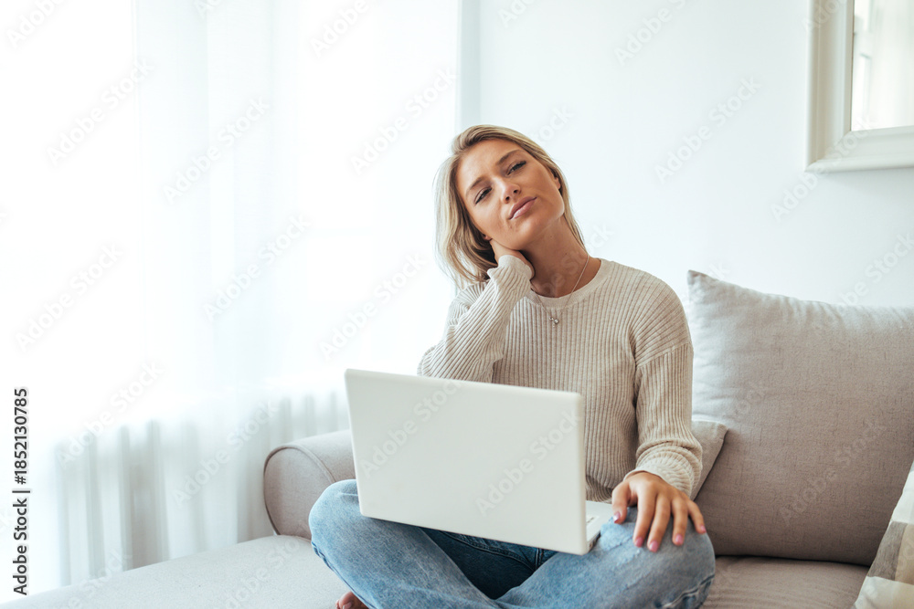 Fototapeta premium Relaxed Woman Working on Laptop at Home Couch in Natural Light, Casual Cozy Scene Today