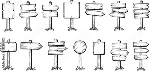 Set of wooden blank directional signs on grassy posts