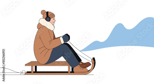A person wearing headphones and a winter hat enjoys a thrilling sled ride down a snowy hill on a bright winter day.