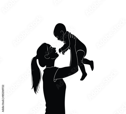 A silhouette of a mother lovingly holds her baby up in the air with joy