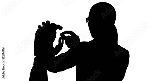 Woman examining a robotic prosthetic hand with circuit board details.