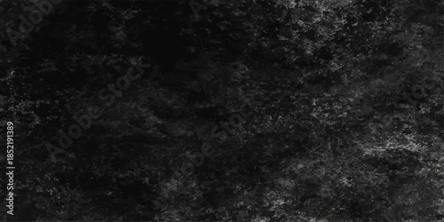 Abstract black and white paper texture with a dark grunge wall pattern creates a vintage textured backdrop featuring a rough gray stone surface and old dirty blank chalkboard design. Black concrete