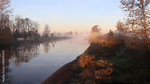 Hazy morning panorama with tranquil river