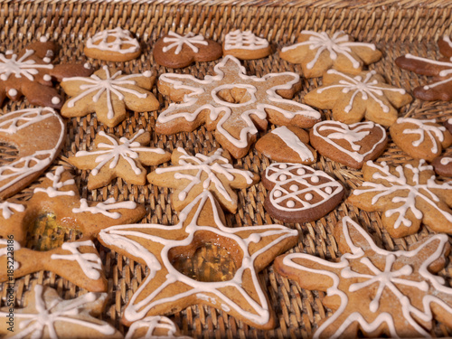 Decorated Christmas gingerbread cookies on wicker tray