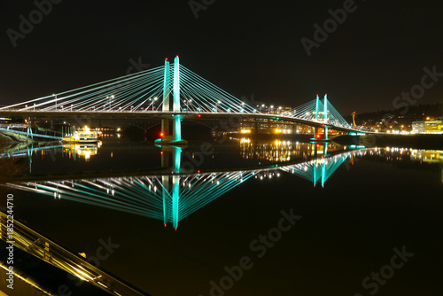 United States, Oregon, Portland. The Tillicum Crossing bridge spans the Willamette River. The cable-stayed bridge is lit at night.