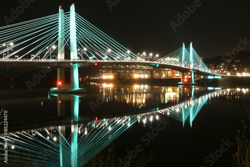 United States, Oregon, Portland. The Tillicum Crossing bridge spans the Willamette River. The cable-stayed bridge is lit at night.
