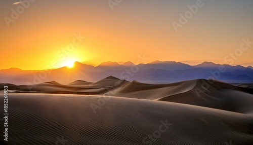 Sunrise Over A Mountain Range And Sand Dunes