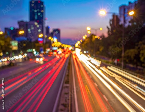 Dynamic light trails from vehicles speeding through a bustling city at dusk, capturing a vibrant urban night scene with blurred architecture