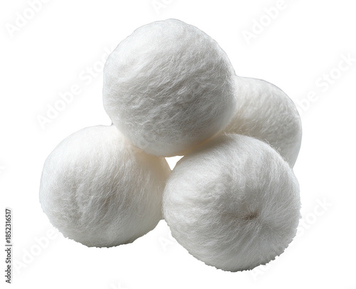 Stacked, soft, fluffy white cotton balls on a solid black background
