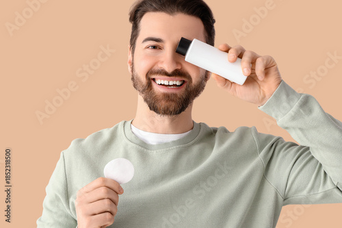 Handsome man with bottle of...