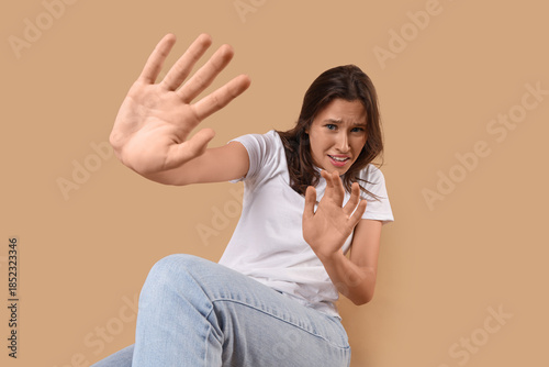 Scared young woman sitting ...