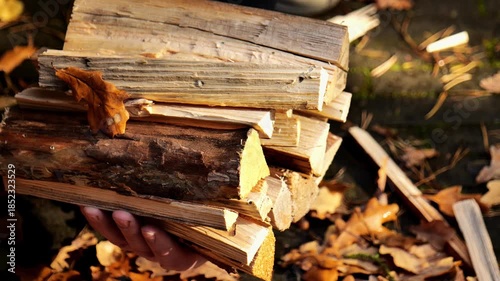 Mens hands stacking firewood.Preparing firewood for the heating season. 4k footage