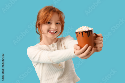 Smiling redheaded girl hold...