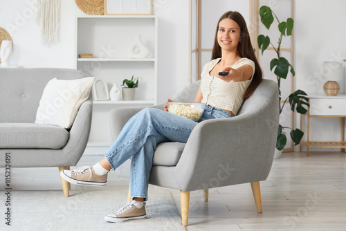 Young woman with remote con...