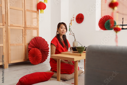 Young Asian woman brewing t...