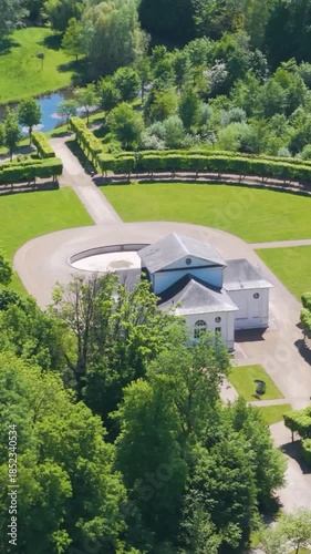 château seneffe along theater building surrounding areas presence green trees water bodies enhances natural to left right pans aerial of de belgium 