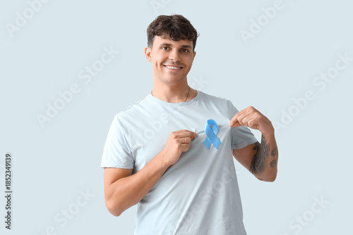 Young man with blue ribbon ...