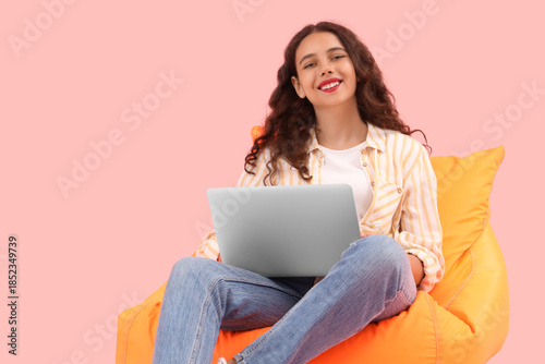 Female student using laptop...