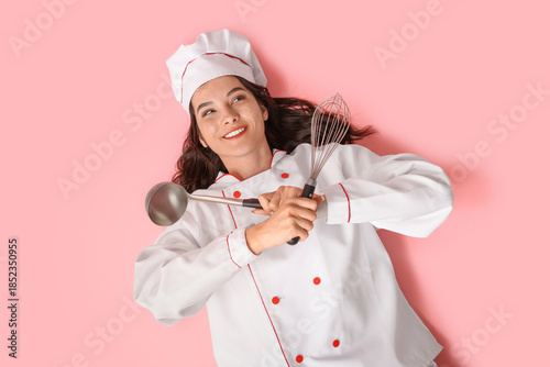 Happy young female cook wit...