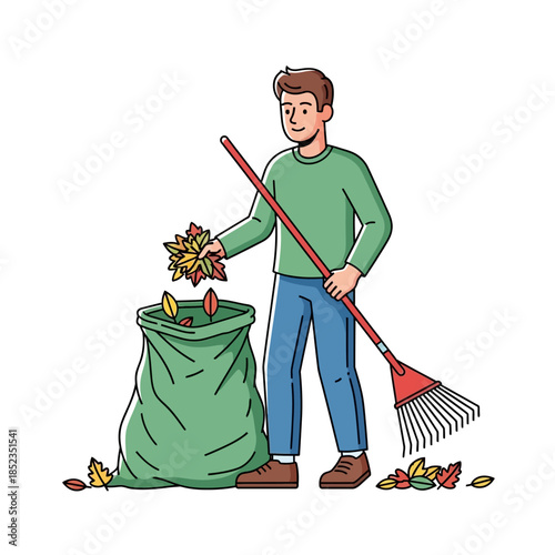 A young man raking fallen leaves into a large green trash bag