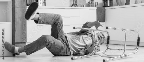 Quadro su tela Senior man with walker falling on floor in kitchen
