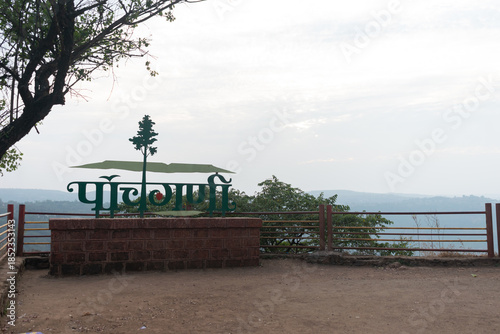 Panchgani viewpoint sign with Panchgani written in Marathi, overlooking Sahyadri hills and railings, capturing hill station tourism near Mahabaleshwar, a scenic destination famous for Strawberry farms