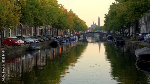 Leiden, Netherlands – September 21, 2024 Canal Reflection St Joseph Church Leiden Netherlands 4K UHD.Boats line a canal in Leiden in The Netherlands. The St Joseph church in the background reflects. 