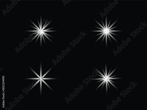 PrintFour bright white starbursts against a solid black background creating a sparkling effect