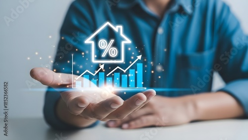 Businessman holding a glowing house icon with a percentage sign and growth chart