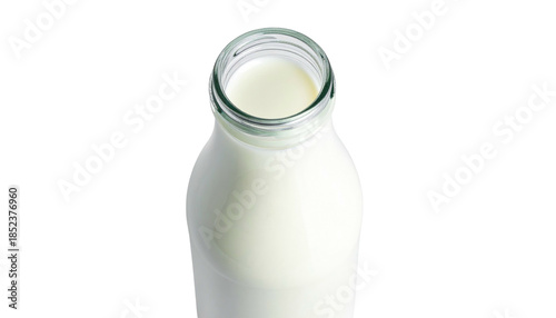 Fresh white liquid beverage in glass bottle, isolated against black background in an overhead, minimalist composition