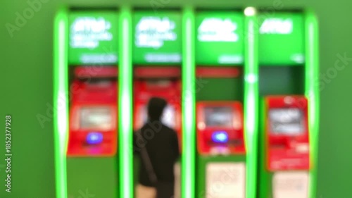 Blurred  Automated Teller Machines or ATM  in the shopping mall.