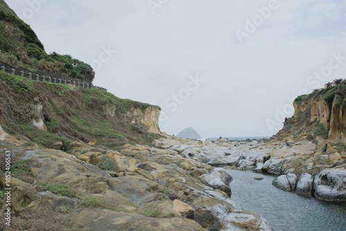Majestic sandstone cliffs and eroded rock formations along the coastal valley of Heping Island Park, Keelung, Taiwan.