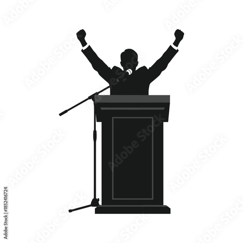 Man standing behind podium with raised fists