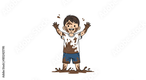 Happy and cheerful young boy covered in mud from head to toe smiling and raising his hands in a playful messy puddle.