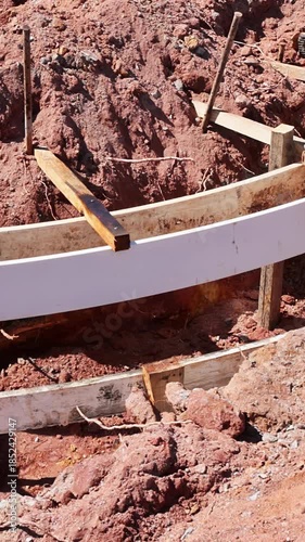 Set up wooden forms in preparation for pouring concrete at construction site under curbed is concrete installation