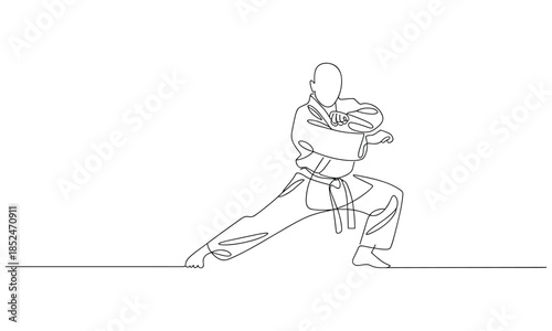 Man in martial arts uniform striking a powerful kick