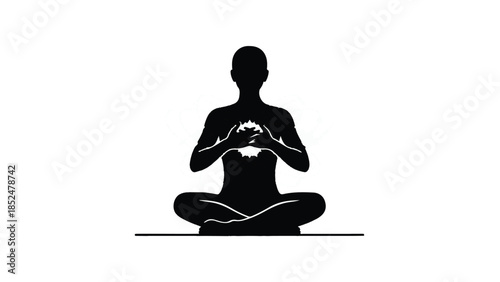 Silhouette of a person in meditation, radiating inner light and peace.